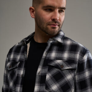 warm men's shacket featuring a cream borg lining, 2 chest pockets and 2 side pockets. horn buttons. comfort fit